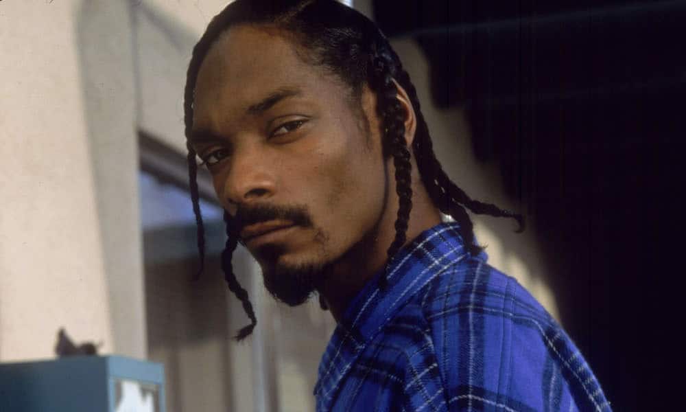 Snoop mean mugging into the camera wearing his gang grip colors.