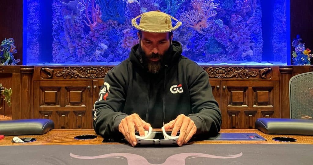 Dan Bilzerian at a poker table wearing hat.