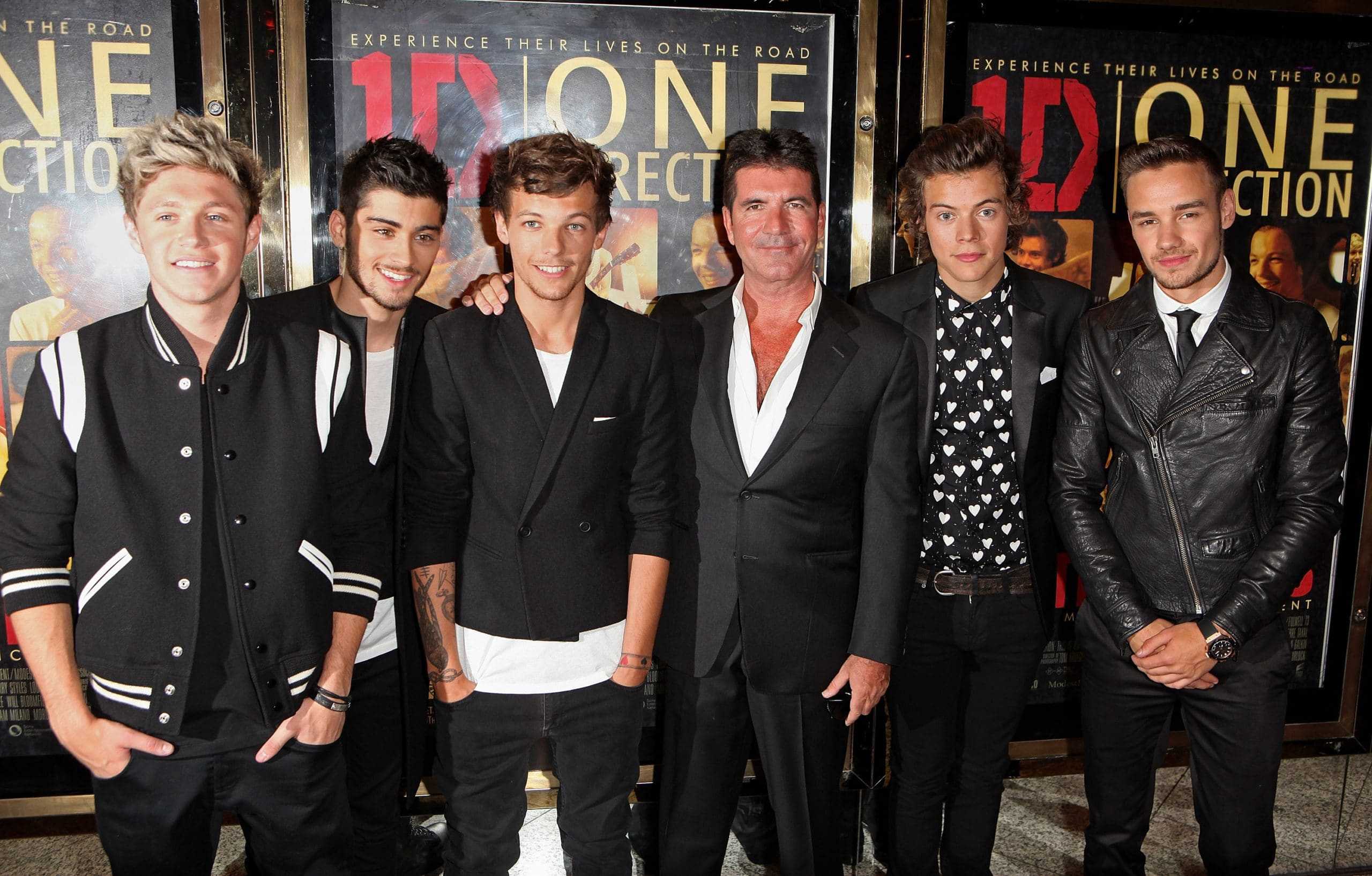 Simon Cowell poses with One Direction