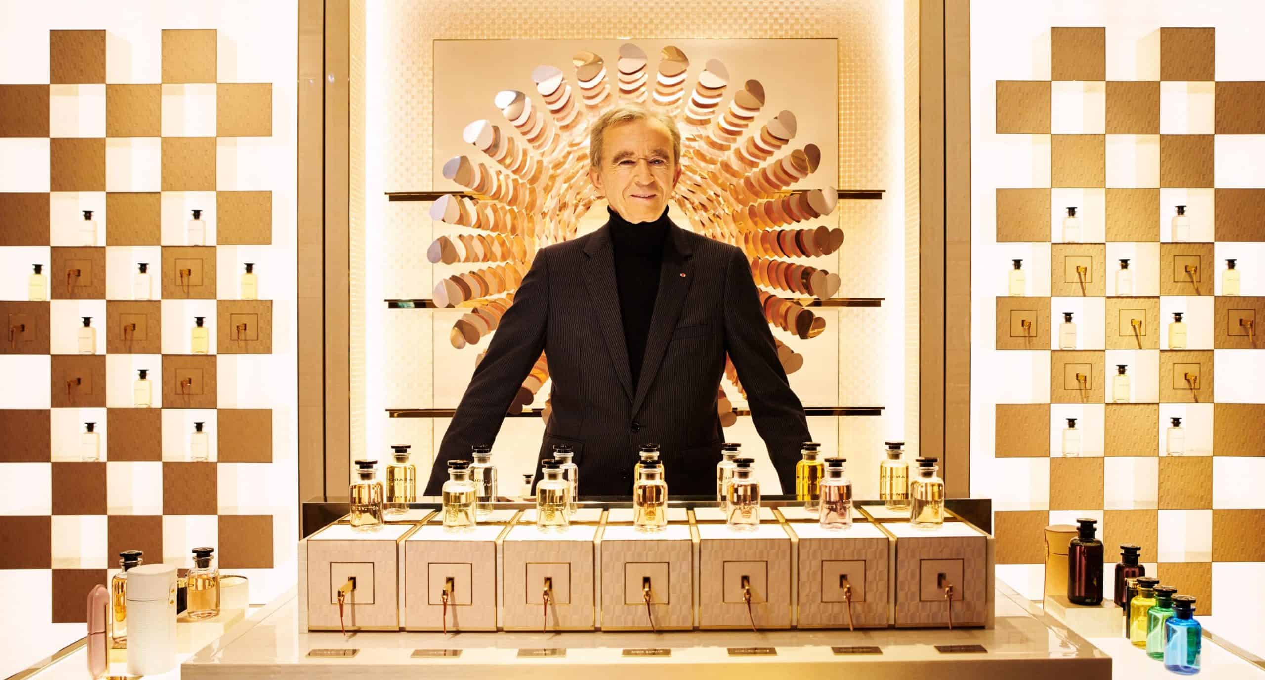 Bernard Arnault standing near perfume.