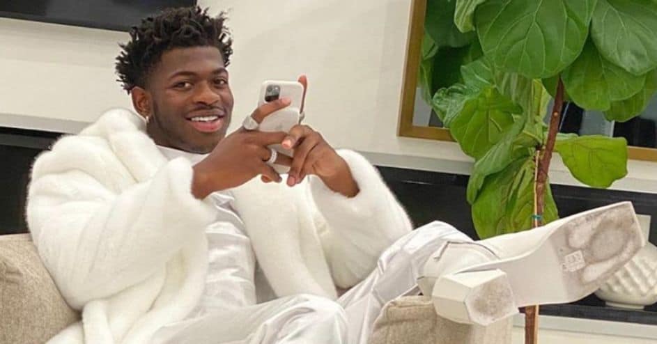 Lil Nas X sitting in a couch