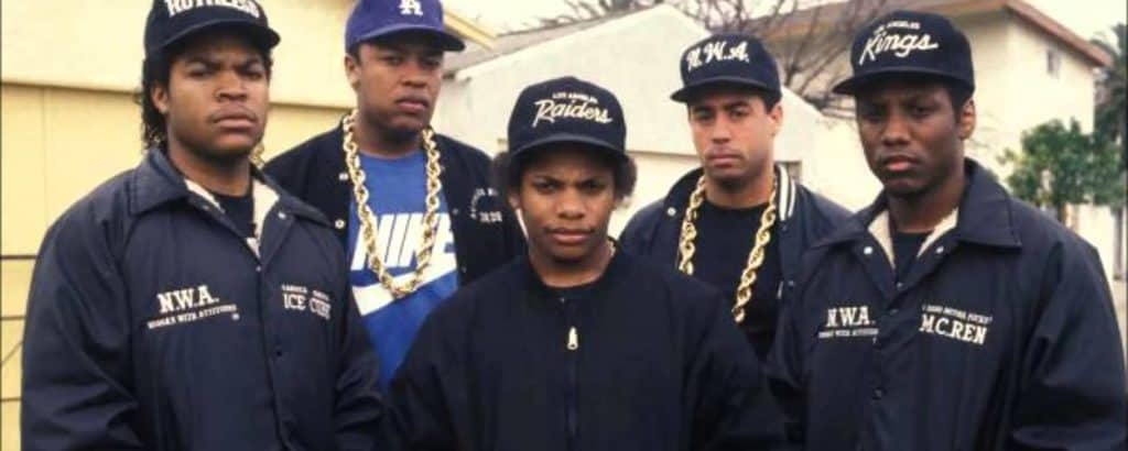 Rap Group N.W.A posing in front of house. Ice Cube on the far left