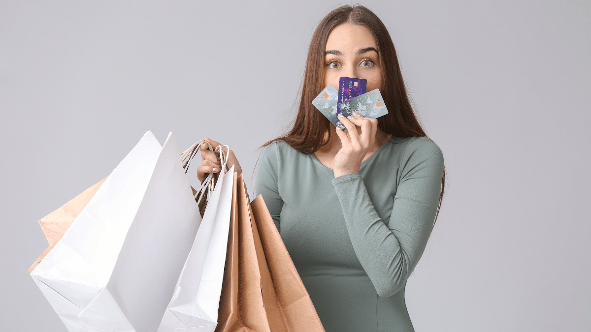 College student holding shopping bags and credit cards