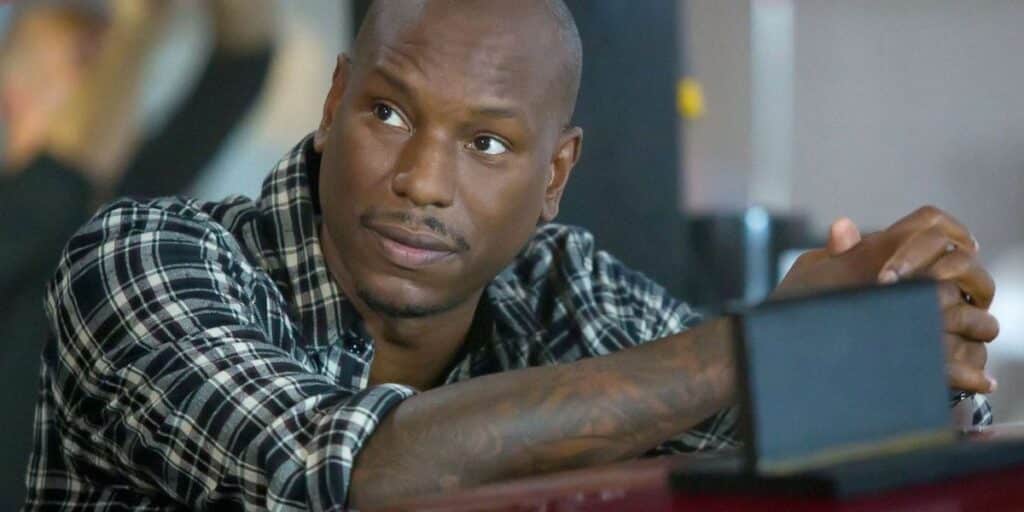 Tyrese Gibson sitting in a chair during the Fast And Furious Movie