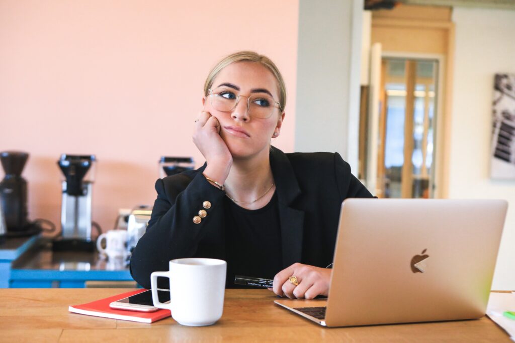 Woman working from laptop looking irritated