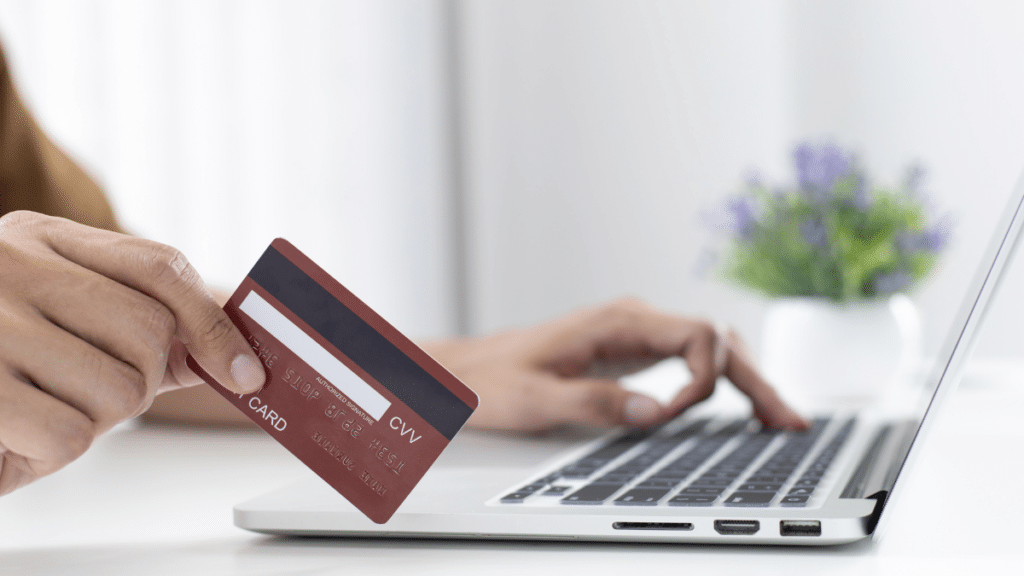 Woman using credit card to purchase something online
