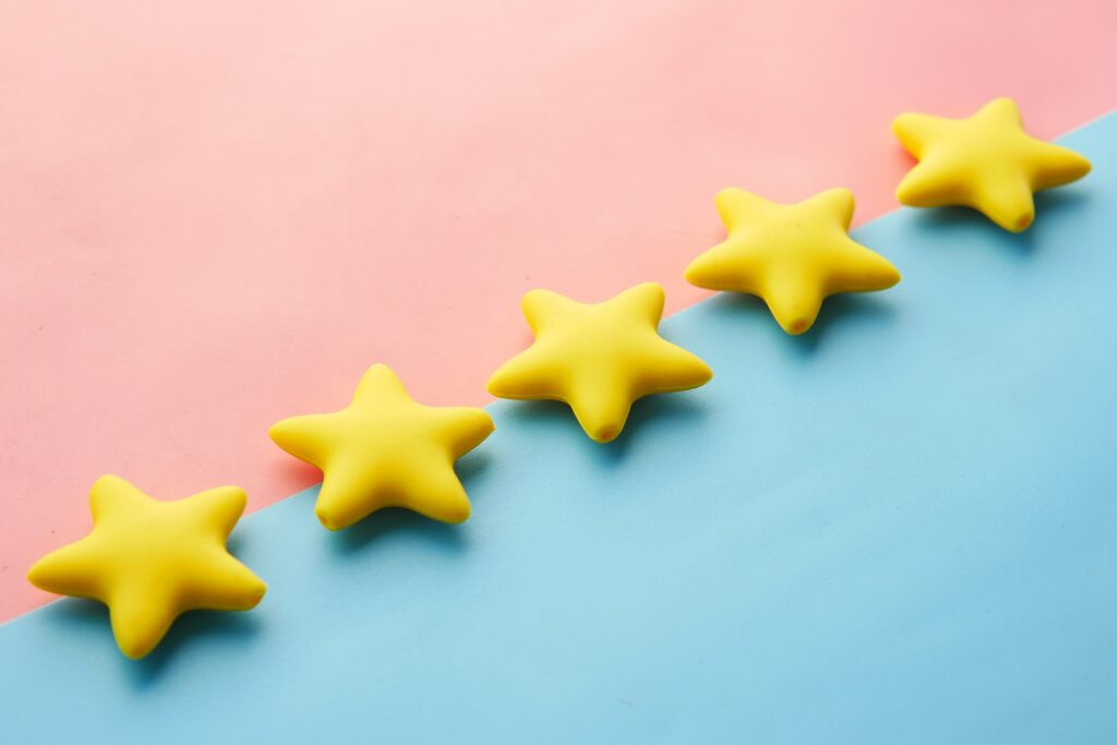 Image of 5 yellow stars on blue and pink background