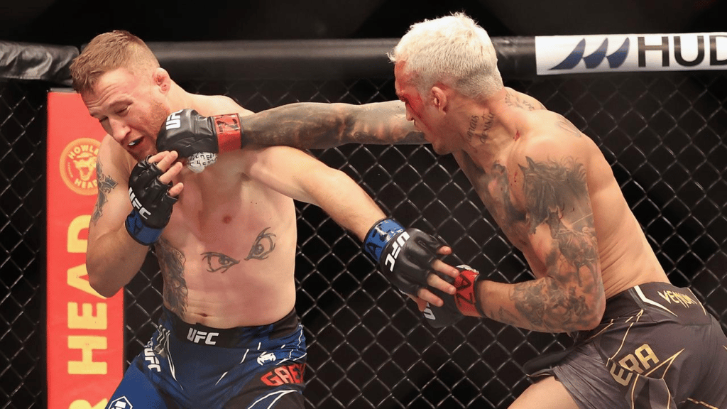 Charles Oliveira (R) of Brazil throws a right on Justin Gaethje in their UFC lightweight championship bout